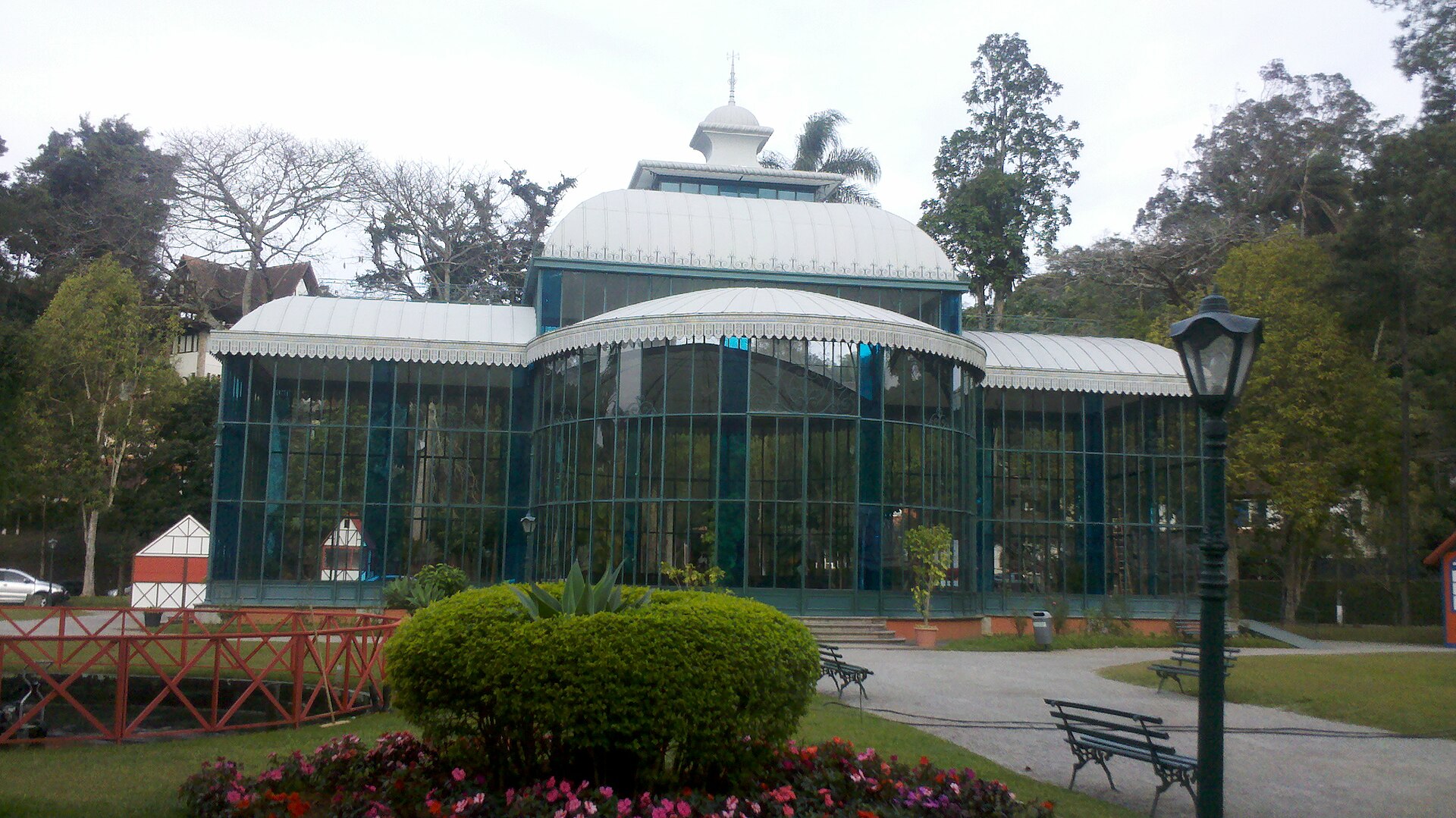 Palácio de Cristal visto de frente, cercado por jardins, em Petrópolis.